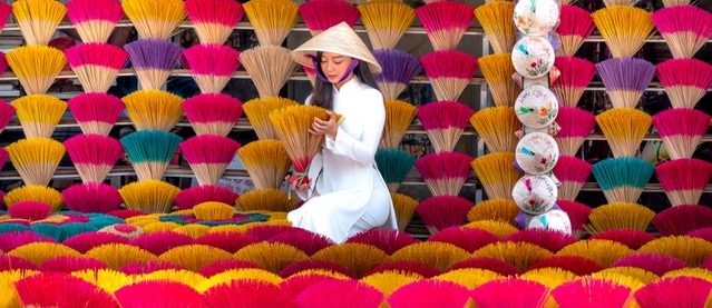 Picture of a lady surrounded by colourful bundles